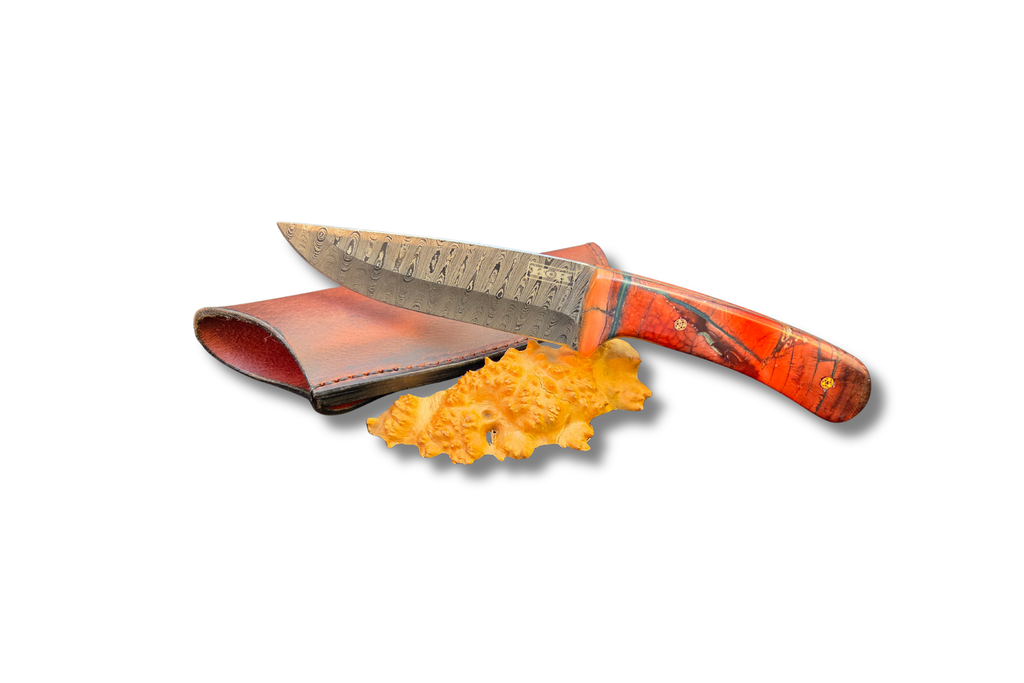 Damascus Skinner Knife with Mammoth Tooth handle: orange, red and blue handle details with leather sheath on a white background